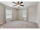 Bright main bedroom features neutral walls, carpet floors, ceiling fan, and curtains at 953 E 34Th St, Indianapolis, IN 46205