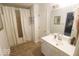 Bright bathroom featuring a vanity with a sink, mirror, and tiled floors at 982 Ramsgate Rd, Greenwood, IN 46143