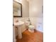 Cozy half-bathroom features pedestal sink, toilet, and wainscoting, perfect for guests at 982 Ramsgate Rd, Greenwood, IN 46143