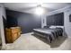 Modern bedroom with a dark accent wall and warm-toned wooden furniture at 982 Ramsgate Rd, Greenwood, IN 46143
