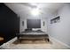 Bedroom with black accent wall, light grey walls, and dark wood furnishings at 982 Ramsgate Rd, Greenwood, IN 46143