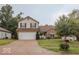 Two-story home featuring a two car garage, well-manicured lawn and mature trees at 982 Ramsgate Rd, Greenwood, IN 46143