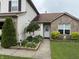 Charming home entrance with brick accents, green shrubs, garden bed and well-maintained lawn at 982 Ramsgate Rd, Greenwood, IN 46143