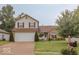 Two-story home with an attached garage, well-maintained lawn, and mature trees at 982 Ramsgate Rd, Greenwood, IN 46143
