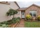 Charming home featuring brick accents and a landscaped front yard with mature plantings and decorative statue at 982 Ramsgate Rd, Greenwood, IN 46143