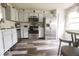 Modern kitchen features stainless steel appliances, gray cabinetry, wood-look floors, and bright natural light at 982 Ramsgate Rd, Greenwood, IN 46143