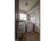 Laundry room featuring tile flooring, a light, a window, and a washer and dryer at 982 Ramsgate Rd, Greenwood, IN 46143