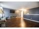 Large open living area featuring hardwood floors and gray accent wall with TV at 982 Ramsgate Rd, Greenwood, IN 46143