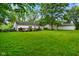 Well-maintained backyard with lush lawn, mature trees, and a patio at 99 Old Trail Dr, Bargersville, IN 46106