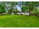 Private backyard featuring mature trees, a large lawn, and deck at 99 Old Trail Dr, Bargersville, IN 46106