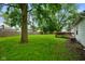 Large backyard with a wooden fence, mature trees, and green grass at 99 Old Trail Dr, Bargersville, IN 46106