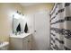 A bright bathroom featuring a vanity, toilet, shower with decorative curtain and modern lighting at 99 Old Trail Dr, Bargersville, IN 46106