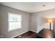 This cozy bedroom features hardwood floors, a window with natural light, and neutral paint at 99 Old Trail Dr, Bargersville, IN 46106