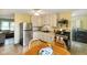 Bright eat-in kitchen with stainless steel appliances, wood table, and tile floor at 99 Old Trail Dr, Bargersville, IN 46106