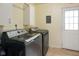 This laundry room features a modern washer and dryer set, along with cabinetry for storage at 99 Old Trail Dr, Bargersville, IN 46106