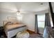 A comfortable bedroom with a ceiling fan, hardwood floors, and natural light at 99 Old Trail Dr, Bargersville, IN 46106