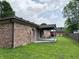 Brick house with a covered patio surrounded by a lush green lawn at 100 Justin Dr, Mooresville, IN 46158