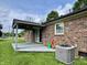 Charming brick home featuring a covered patio and well-kept lawn at 100 Justin Dr, Mooresville, IN 46158