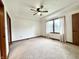 Inviting bedroom boasts a ceiling fan and a large window with curtains at 100 Justin Dr, Mooresville, IN 46158