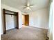 Bedroom with neutral carpeting, a ceiling fan, and an open closet at 100 Justin Dr, Mooresville, IN 46158