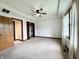 Comfortable bedroom featuring a ceiling fan, neutral carpet, and ample closet space at 100 Justin Dr, Mooresville, IN 46158