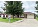 Charming brick ranch home with a well-manicured lawn and mature shade tree at 100 Justin Dr, Mooresville, IN 46158