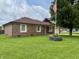 Charming brick home with a well-manicured lawn and an American flag waving in the background at 100 Justin Dr, Mooresville, IN 46158