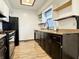 Functional kitchen featuring wood cabinets, and black appliances at 100 Justin Dr, Mooresville, IN 46158