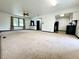 Large living room featuring neutral carpet with kitchen view at 100 Justin Dr, Mooresville, IN 46158