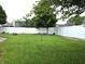 Large, well-manicured backyard enclosed by a white vinyl fence at 1027 Springway Dr, Shelbyville, IN 46176