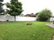 Large, well-manicured backyard featuring a white vinyl fence and a gazebo at 1027 Springway Dr, Shelbyville, IN 46176