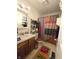 Bathroom showcasing a wooden vanity, toilet, patterned shower curtain, and shelving for linens at 1027 Springway Dr, Shelbyville, IN 46176