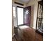 Entryway with wood floors leading to an open door with natural light shining in at 1027 Springway Dr, Shelbyville, IN 46176