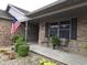 Charming brick home featuring an inviting front porch and well-manicured landscaping at 1027 Springway Dr, Shelbyville, IN 46176