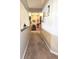 Hallway with carpet and various pictures and wall decorations hung on the wall at 1027 Springway Dr, Shelbyville, IN 46176