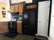 Cozy kitchen showcasing wooden cabinets, modern appliances, and checkered tile floors at 1027 Springway Dr, Shelbyville, IN 46176