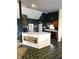 Spacious eat-in kitchen area featuring dark walls, tile floors, a large island, and lots of cabinet storage at 1027 Springway Dr, Shelbyville, IN 46176