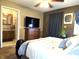 Primary bedroom featuring ensuite bathroom, a bed, and a ceiling fan; ideal for relaxation and privacy at 1027 Springway Dr, Shelbyville, IN 46176