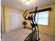 Workout room featuring an elliptical, fan, a window and neutral carpet at 1027 Springway Dr, Shelbyville, IN 46176