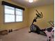 Workout room featuring an elliptical, kettle bells, a window and neutral carpet at 1027 Springway Dr, Shelbyville, IN 46176