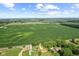 Expansive aerial view of a home surrounded by vast fields, showcasing the rural setting and serene countryside landscape at 10727 N Shupe Rd, Monrovia, IN 46157