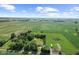 Wide aerial shot of a property highlighting its green fields, pool, additional structures, and quiet rural surroundings at 10727 N Shupe Rd, Monrovia, IN 46157