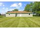 Back view of home featuring well-manicured lawn, windows and a backdoor with good lighting at 10727 N Shupe Rd, Monrovia, IN 46157