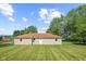 View of the rear exterior, featuring a well-maintained lawn, a simple design and natural light at 10727 N Shupe Rd, Monrovia, IN 46157