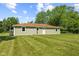 A well-maintained backyard features a home with light siding, a brown roof, and lots of green space at 10727 N Shupe Rd, Monrovia, IN 46157