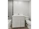 Modern bathroom featuring a white vanity, grey tile accents, and a toilet at 10727 N Shupe Rd, Monrovia, IN 46157