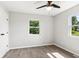 Bedroom with hardwood floors, neutral walls, two windows with exterior views, and a ceiling fan at 10727 N Shupe Rd, Monrovia, IN 46157