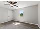 Bright bedroom featuring wood floors, neutral walls, window with green view, and white trim, with a ceiling fan at 10727 N Shupe Rd, Monrovia, IN 46157