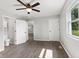 This bedroom has beautiful vinyl floors, a ceiling fan, neutral walls, and two doors, one to the bathroom at 10727 N Shupe Rd, Monrovia, IN 46157