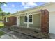 Charming home featuring a covered porch with white columns, brick accents, and updated siding next to an attached garage at 10727 N Shupe Rd, Monrovia, IN 46157